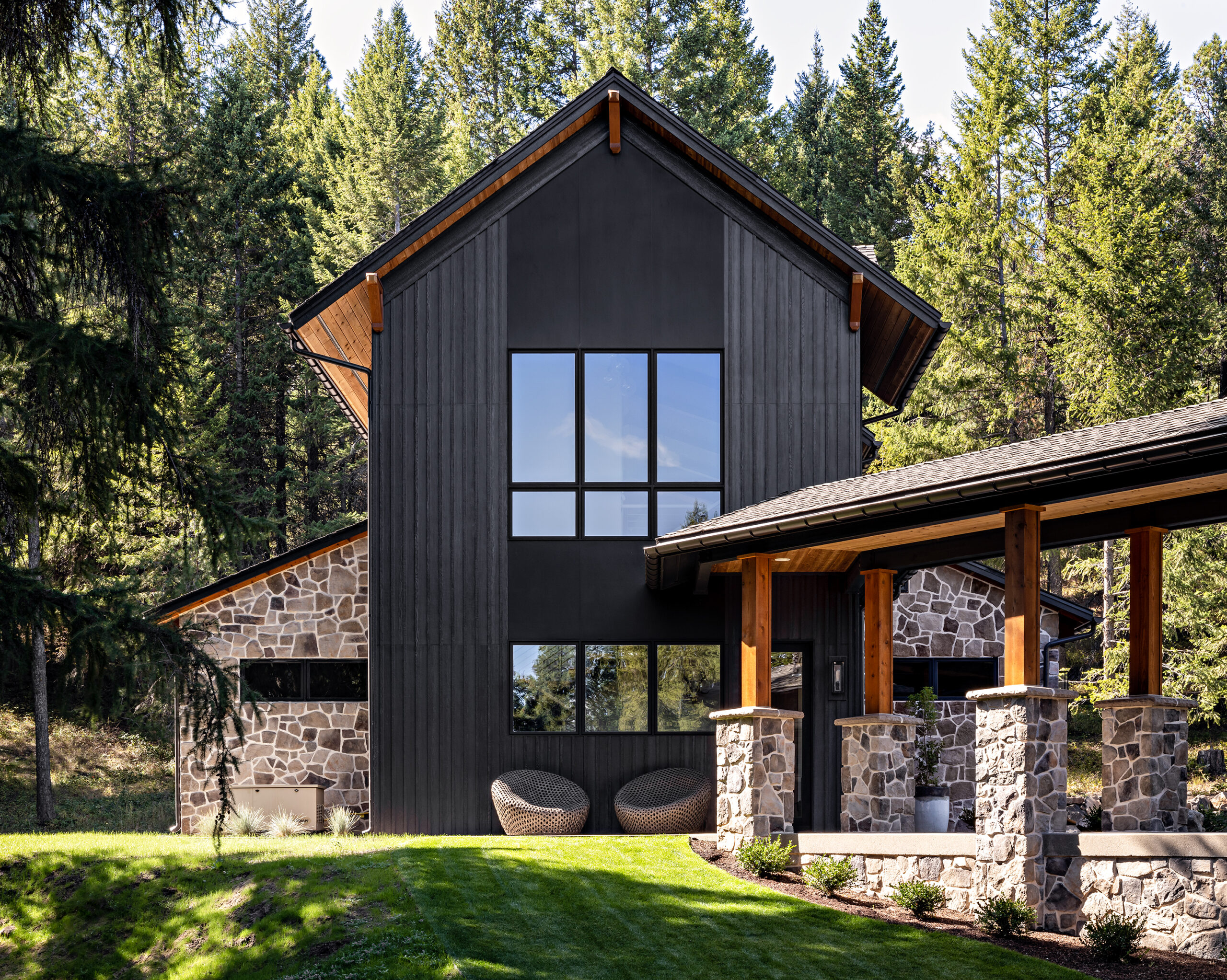 Modern outdoor living space with stone accents and lush greenery