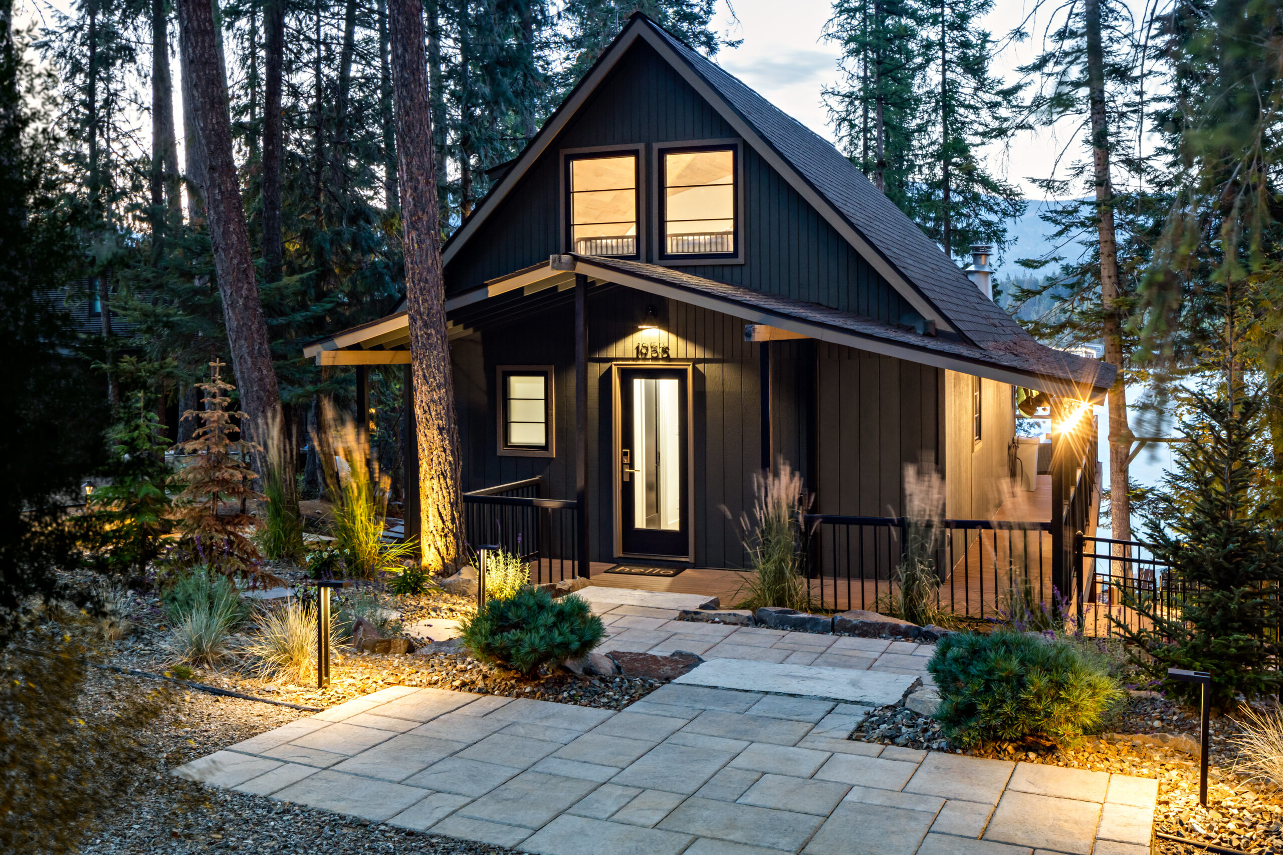 A-frame cabin with custom landscape lighting and stone pathways